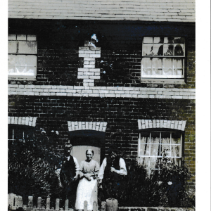 maybe Horatio Paske Arthur Orris Ellen Paske outside one of the cottages on the Green